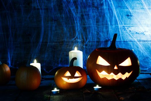Jack O Lantern Halloween pumpkin with witches hat , spiders on web and burning candles