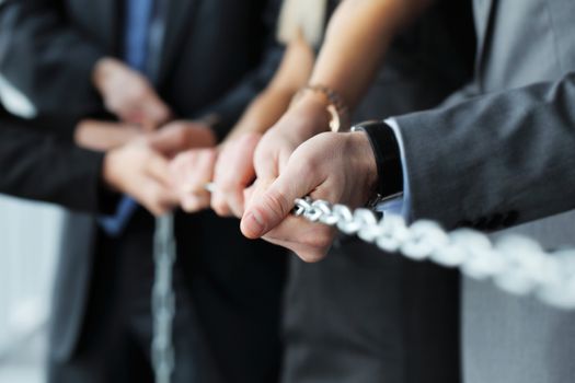 Businessmen pulling chain, teamwork togetherness concept