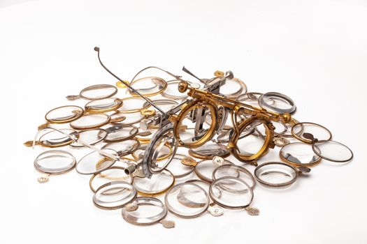 Old optometric devices and set of lenses on an isolated studio background