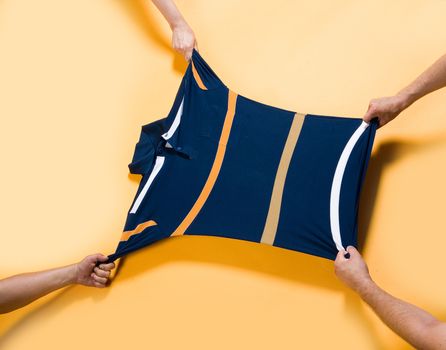 Four hands pulling the shirt
