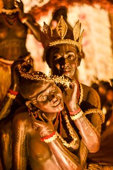 KOLKATA , INDIA SEPTEMBER 26, 2017 - Decorated art and craft sculptures of Traditional tribal Santal or Santhal ethnic group dancers making love wear traditional clothing in famous Durga Puja pandal.