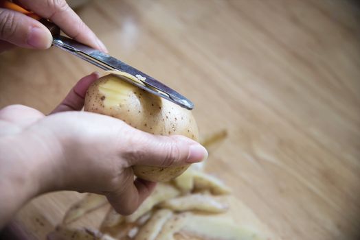 People cooking fresh potato preparing food in the kitchen - potato cooking concept