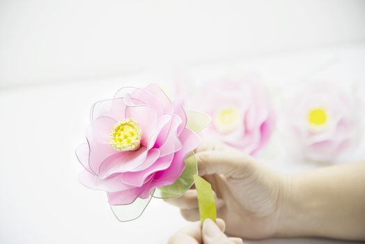 Woman making beautiful nylon flower - people with DIY handmade flower concept