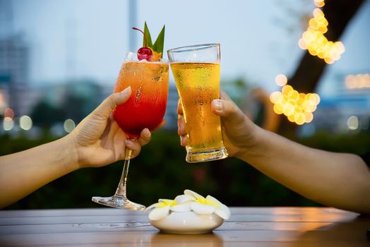 Couple celebration in restaurant with soft drink beer and mai tai or mai thai - happy lifestyle people with soft drink concept