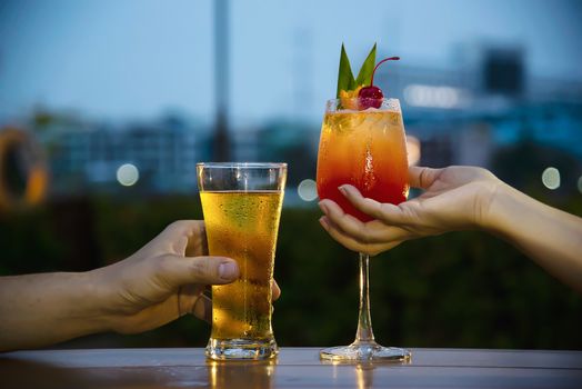 Couple celebration in restaurant with soft drink beer and mai tai or mai thai - happy lifestyle people with soft drink concept