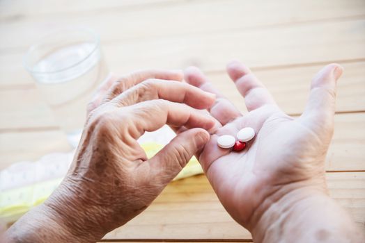 Old lady prepare to eat daily medicine pill - people healthcare with medicine pills concept