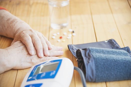 Old lady is being checked blood pressure using blood pressure monitor kid set - people with health care medical instrument set concept