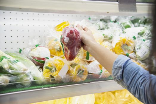 Lady is shopping fresh vegetable in supermarket store - woman in fresh market lifestyle concept