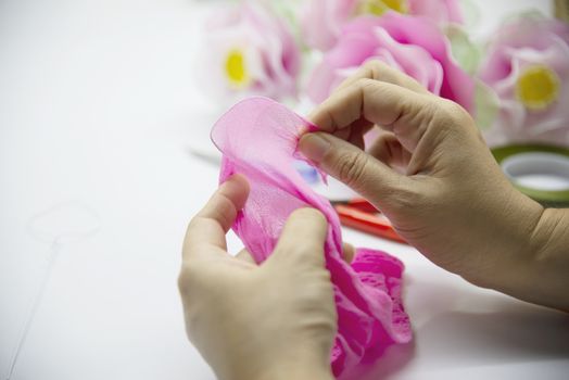 Woman making beautiful nylon flower - people with DIY handmade flower concept