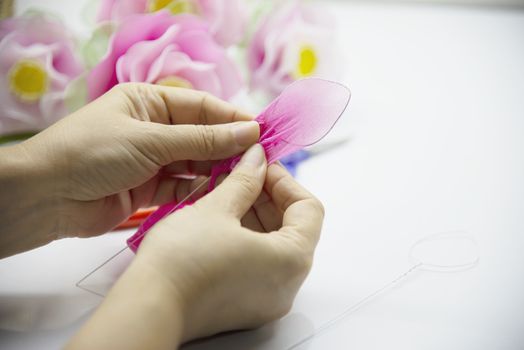 Woman making beautiful nylon flower - people with DIY handmade flower concept