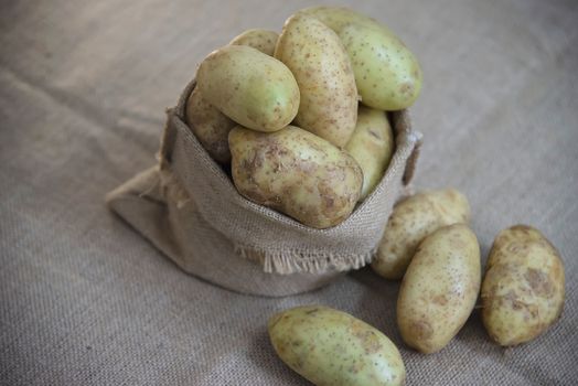 Fresh potato in kitchen ready to be cooked - fresh vegetable preparing for making food concept