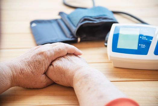 Old lady is being checked blood pressure using blood pressure monitor kid set - people with health care medical instrument set concept