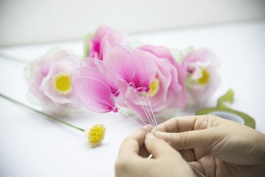 Woman making beautiful nylon flower - people with DIY handmade flower concept