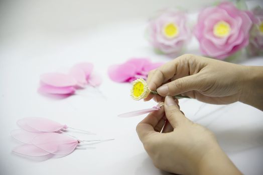 Woman making beautiful nylon flower - people with DIY handmade flower concept