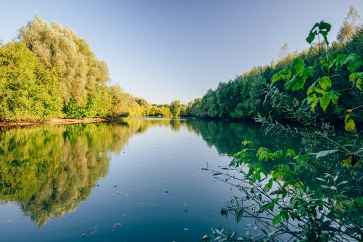 Forest blue lake at autumn clear day