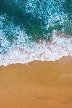 Aerial view of Blue ocean wave on sand beach.