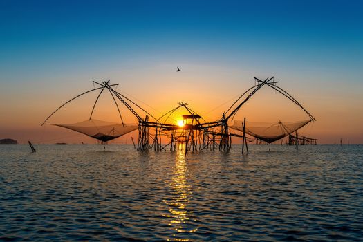 Beautiful sunrise and fishing dip nets at Pakpra in Phatthalung, Thailand.