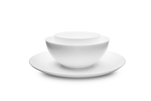 Set of white dishes on table on light background. With clippig path