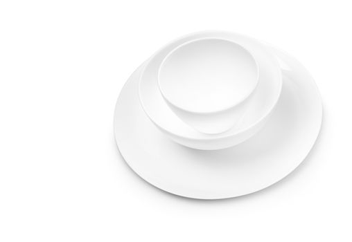 Set of white dishes on table on light background. With clippig path