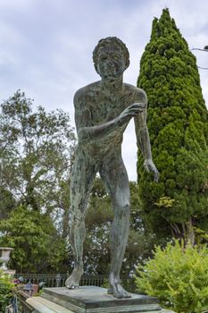 Achilleion palace, Corfu, Greece - August 24, 2018: Bronze runner on Achilleion palace of princess Sissy in Corfu, Greece