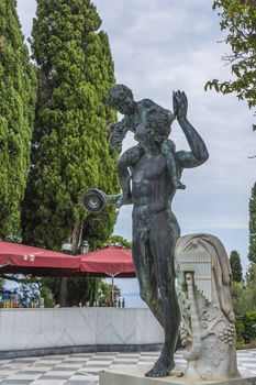 Achilleion palace, Corfu, Greece - August 24, 2018: Bronze man with boy on Achilleion palace of princess Sissy in Corfu, Greece