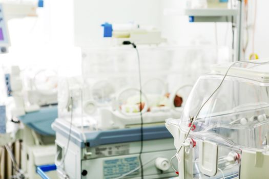 Newborn baby in hospital incubator.