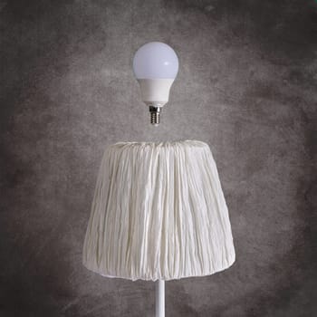 a light bulb above a white lamp