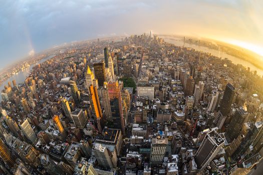 New York City skyline with Manhattan skyscrapers at dramatic stormy sunset, USA. Fish eye wide angle view.