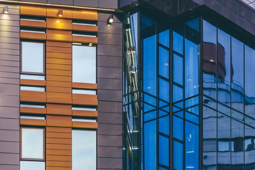 Modern high-rise office building with a glass facade, background.