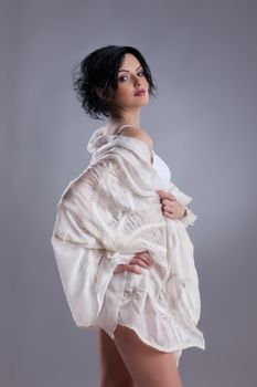 Young attractive woman dressed in handmade clothing on isolated background