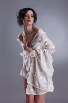 Young attractive woman dressed in handmade clothing on isolated background