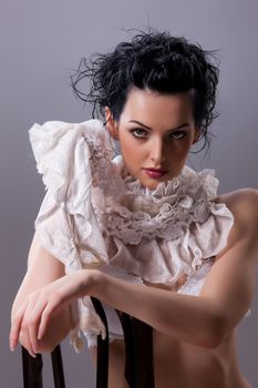Young attractive woman dressed in handmade clothing on isolated background