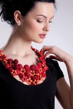 Young attractive woman dressed in handmade clothing on isolated background