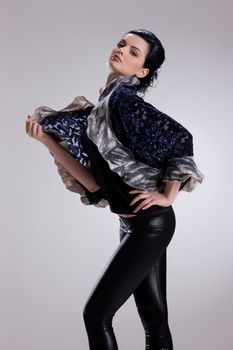 Young attractive woman dressed in handmade clothing on isolated background