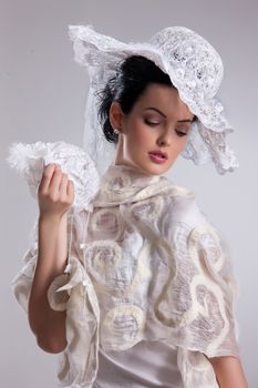 Young attractive woman dressed in handmade clothing on isolated background
