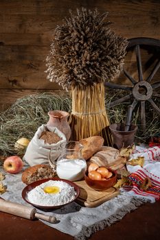 Different kinds of bread and rural accessories on a fabric background
