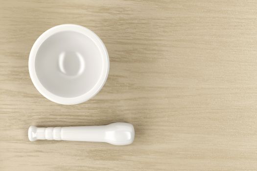 Mortar and pestle on wood table, top view
