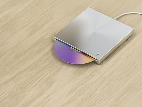 Silver optical disc drive on wood background