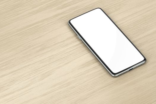Bezel-less smartphone with blank display on wood background