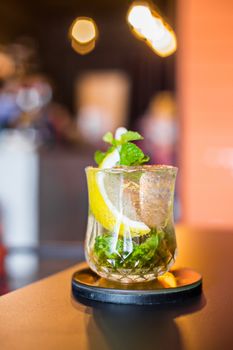 Cocktail mojito with lime slic in glass on table in resturant bar.