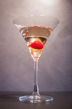 Cocktail alcohol with red cherry on table in resturant bar.