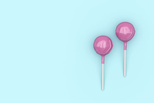 Top view of two pink lollipops on turquoise background