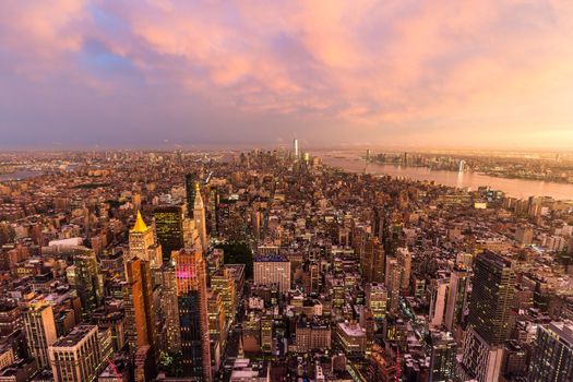 New York City skyline with Manhattan skyscrapers at dramatic vibrant after the storm sunset, USA. Rainbow and lightnings can be seen in background over Brooklyn bridge.