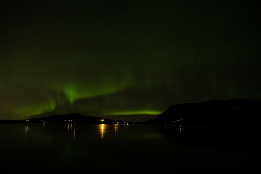 Northern light reflected on the Hafravatn lake, Iceland