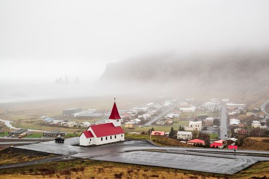 Church in Vik i Myrdal in a foggy day seen from the hill, Iceland