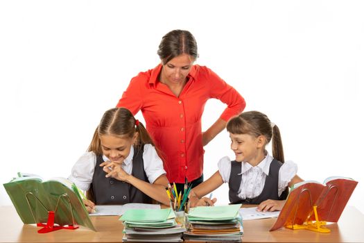 Teacher and student look in the notebook of another student, where something funny