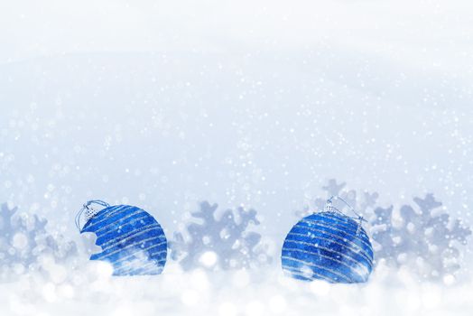 Christmas composition of blue balls and snowflakes in the snow - blank for greeting card or other design, place for text, copy space.