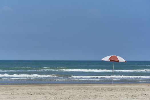 Umbrella and sunbed at the beach landscape with a great blue sky