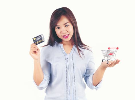 Women holding credit cards and shopping cart, shopping concept