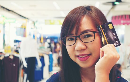 Women holding credit cards and shopping cart, shopping concept